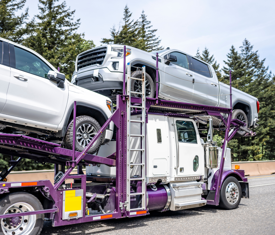 transport truck carrying pickup trucks