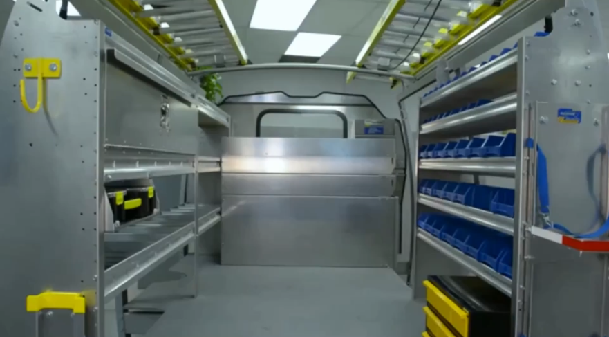 inside of a cargo van outfitted with shelves